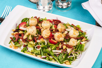 Mediterranean salad of radish, arugula, fried shrimp, chili peppers, cucumbers with olive oil