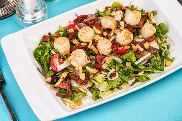 Mediterranean salad of radish, arugula, fried shrimp, chili peppers, cucumbers with olive oil