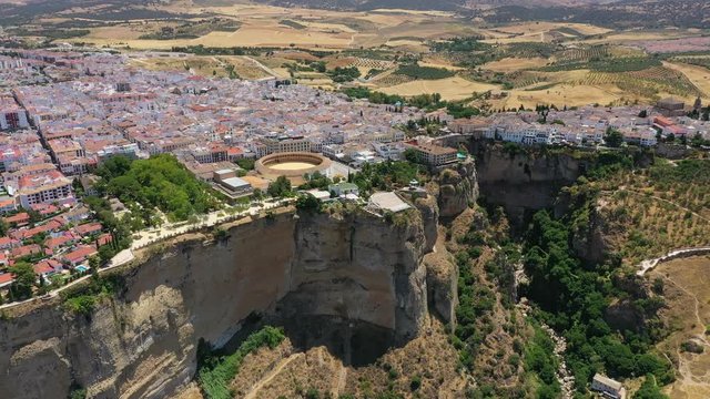 Aerial view of cityscape of Ronda, famous historic city and tourist attraction in Costa del Sol, corrida arena Bullring of the Royal Cavalry - landscape panorama of Andalusia from above, Spain, Europe
