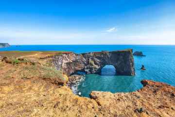 Gorgeous landscape with unique basalt arch on Dyrholaey Nature Reserve on Atlantic South Coast