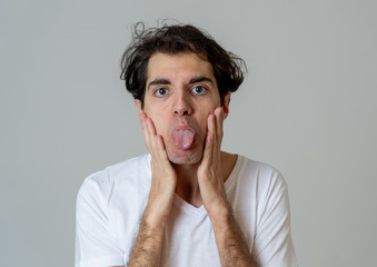 Funny face. Portrait of young man making amusing gestures