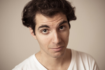 Fototapeta premium Funny face. Portrait of young man making amusing gestures