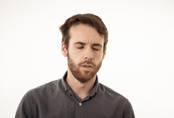 Obraz premium Portrait of sad and depressed man. Isolated in white background. Human expressions and emotions