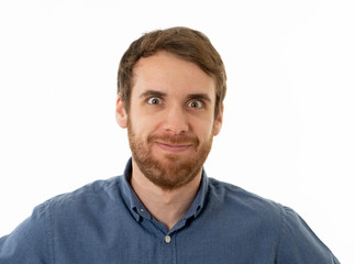 Obraz premium Happy young attractive man shocked with a surprised funny face. Human expressions and emotions.