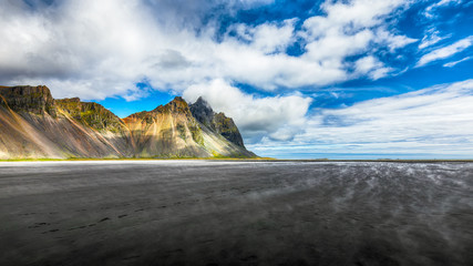 Splendid sunny day and gorgeous reflection of Vestrahorn mountaine on Stokksnes cape in Iceland.