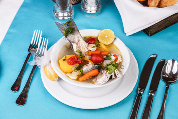 Mediterranean sea-fish soup with vegetables and lemon