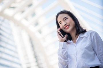 Businesswoman looking smart confidence in casual attire. Was on the phone business communications. among capital
