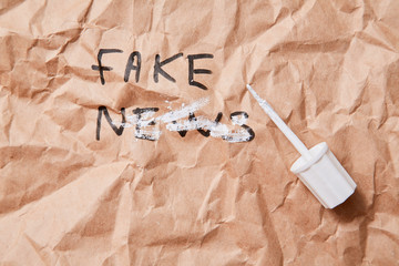 Fake news, disinformation or false information and propaganda concept. Crumpled Kraft paper and...