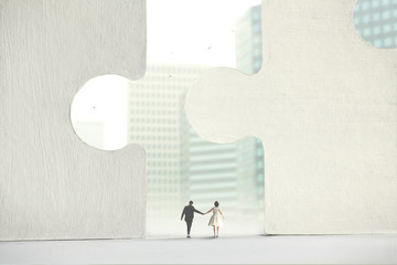 couple who pass under a perfect interlocking of giant puzzles, concept of perfect love