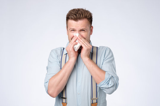 Sick Guy Isolated Has Runny Nose Or Being Allergic On Cat Or Dust.