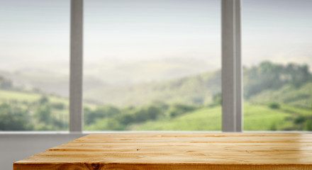 Desk of free space and blurred background of window 