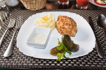 Sliced ​​chicken cutlet, breaded in breadcrumbs from white bread with a side dish of mashed potatoes