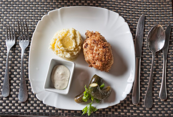 Sliced ​​chicken cutlet, breaded in breadcrumbs from white bread with a side dish of mashed potatoes