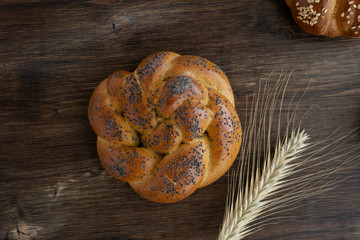 Challah bread on rustic wooden background, top view, copy space