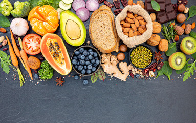 Ingredients for the healthy foods selection. The concept of healthy food set up on dark stone background.