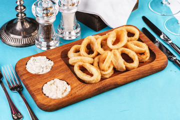 European cuisine, Mediterranean dish. Squid rings fried in batter snack for beer with cream sauce and steamed rice