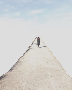 Woman walking along a path towards the sky, South Korea