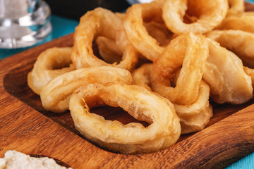 European cuisine, Mediterranean dish. Squid rings fried in batter snack for beer with cream sauce and steamed rice