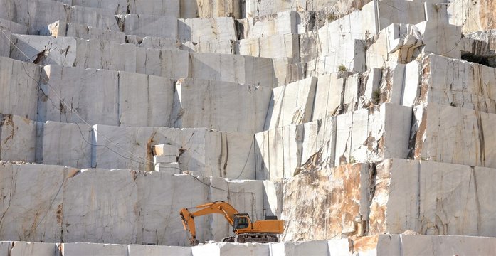 Marble quarry with a Excavator loader, open mining, Italy