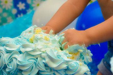 Little hands smashing cake in birthday.