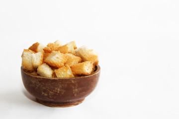 fried dry white bread crackers in a wooden plate on a white background
