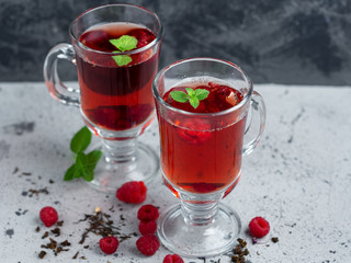 Hot fruit raspberry tea with herbs and lavender in a glass Cup