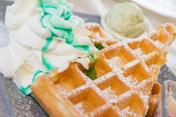 Waffles with whipped cream, mint sauce and mint ice-cream 