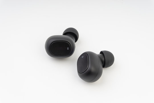 Wireless earbuds or earphones on white background