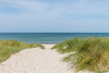 German Baltic Sea coast with sand dunes, grass, water and sky