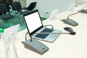 Laptop with blank screen on table.