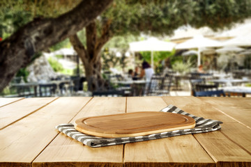 Wooden table of free space and summer restaurant background 