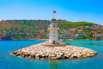 Fototapeta na wymiar Lighthouse in the seaport of the city of Alanya, Turkey.