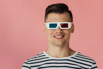 front view of smiling young man in 3d glasses isolated on pink