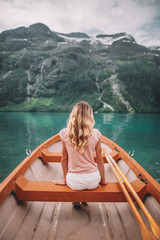 Fototapeta na wymiar young woman in boat in Lovatnet