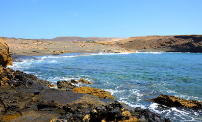 Fototapeta na wymiar Empty Black Sand and Rocky Beach in Fuerteventura, Canary Islands