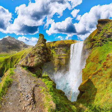 Beautiful scenery of the majestic Skogafoss Waterfall in countryside of Iceland in summer.
