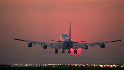 Big airliner landing at sunrise