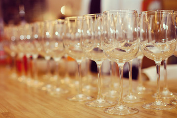 Wine glasses in row on bar