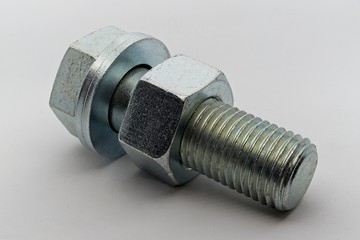 Steel nut, bolt and washers on white background