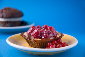 Strawberries tart dessert and chocolate muffin with blue background