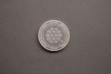 Qtum on gray background. Flat lay, top view perspective