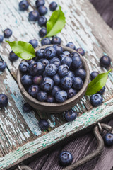 ripe blueberry berries on old wooden table. healthy food