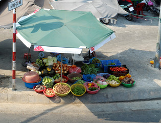 colorful vegetables under large parasol at open air market