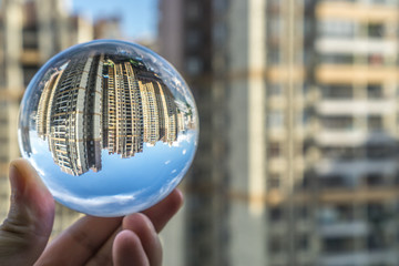 round Glass ball with big city buildings background