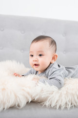 cute happy baby portrait lying on fur