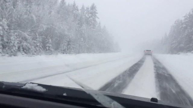 winter roadl in heavy snow with strong blizzard in moving car