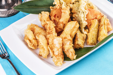 European cuisine, Mediterranean dish. Whole crab legs, crab meat fried in batter on butter, beer snack with creamy mustard sauce