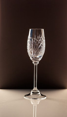 champagne glass standing on a white table against a dark background