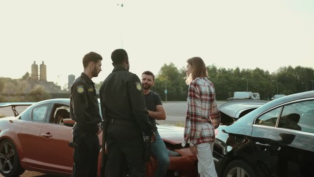 unsatisfied drivers talking with the police trying to olve bad situation on road. view of stressful woman and man arguing in front of policemen.