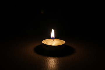 burning candle tablet in the dark